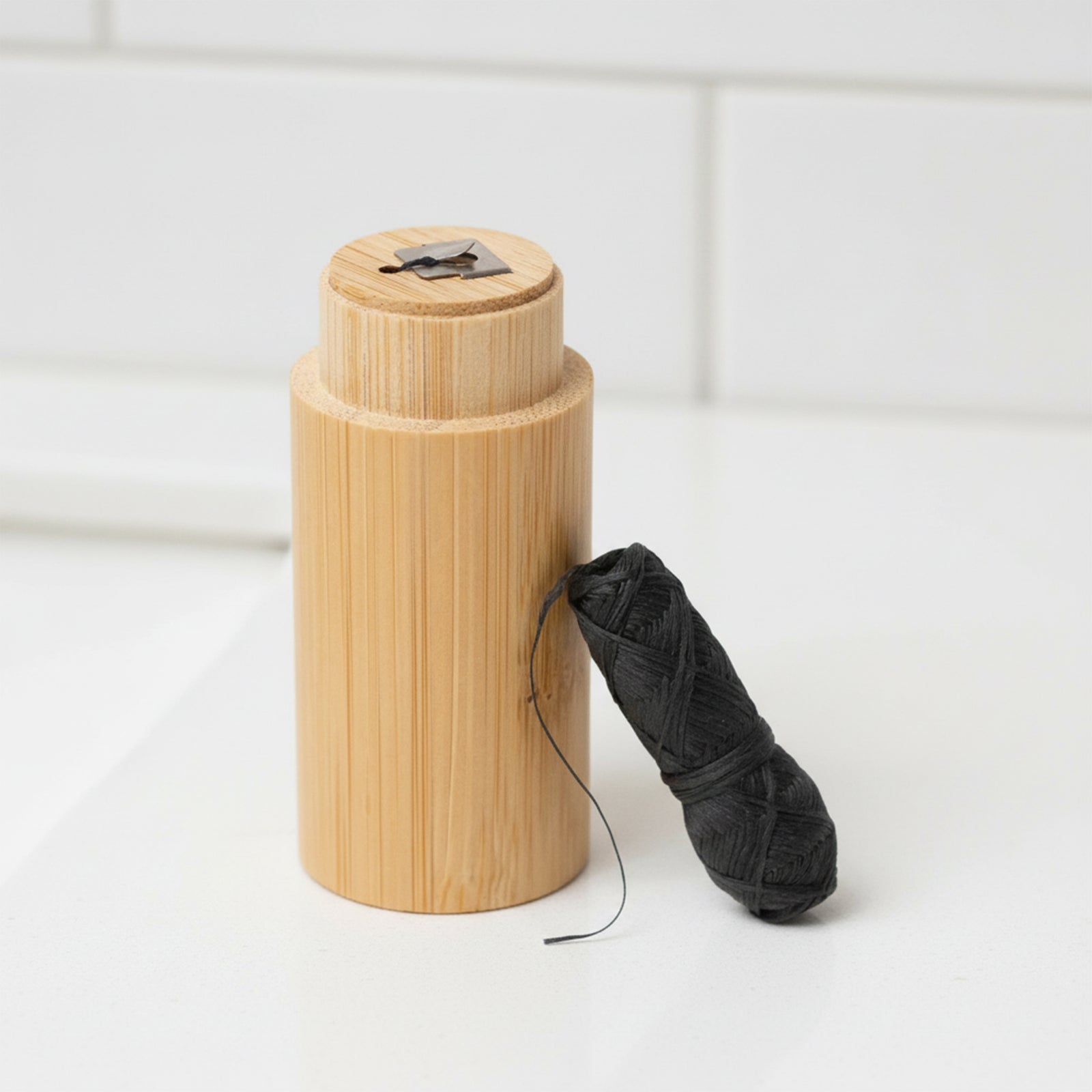 Chomp bamboo floss container with charcoal dental floss