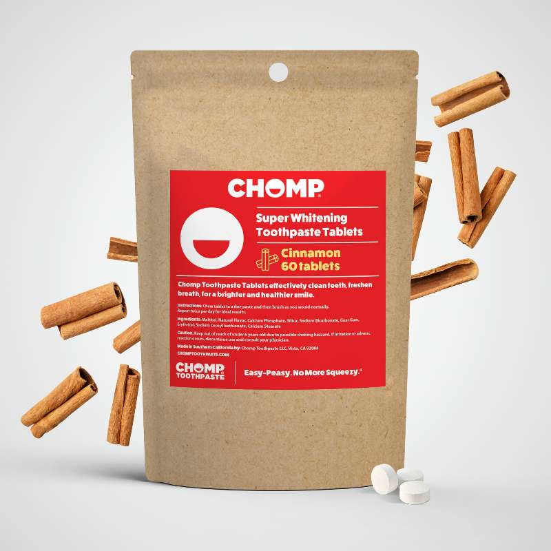 CHOMP super whitening toothpaste tablets packaging with cinnamon sticks on a light gray background