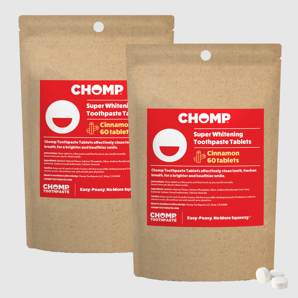 Two packages of CHOMP Super Whitening Toothpaste Tablets with red labels on a light gray background.