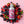 Silver bottle labeled 'CHOMP Junior' surrounded by berries on a pink background