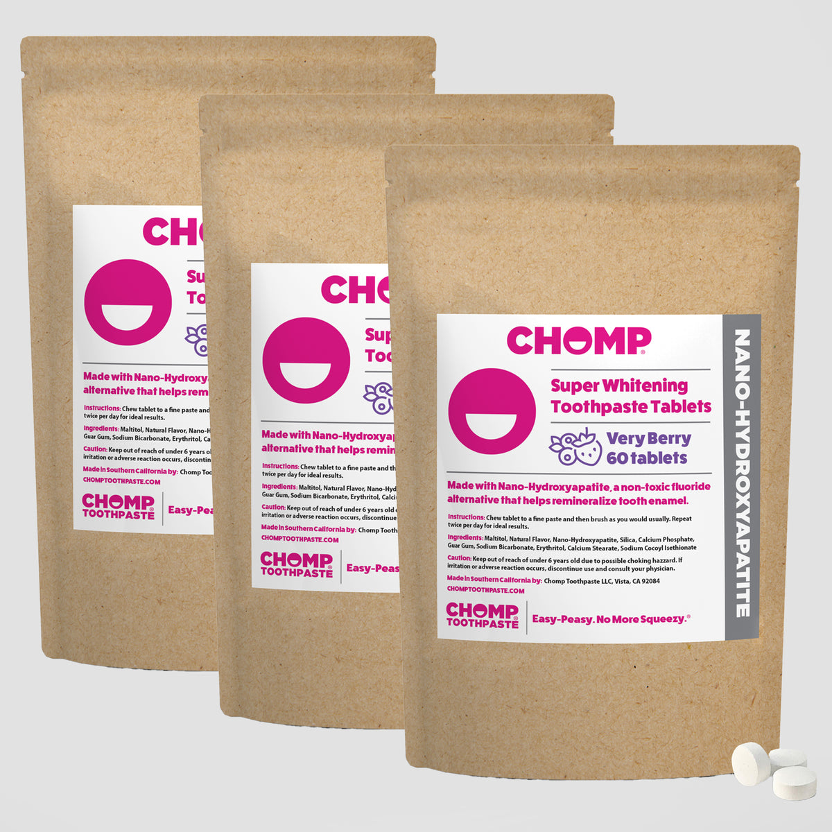 Three packages of CHOMP Super Whitening Toothpaste Tablets on a white background