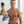 Man holding a package labeled 'CHOMP' in a bathroom setting