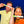Two people holding 'CHOMP' products in front of their faces against a blue background
