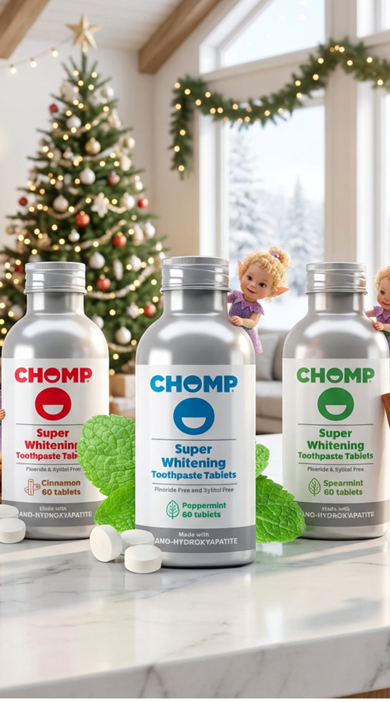 Three bottles of CHOMP Super Whitening Toothpaste Tablets on a kitchen counter with Christmas decorations in the background.