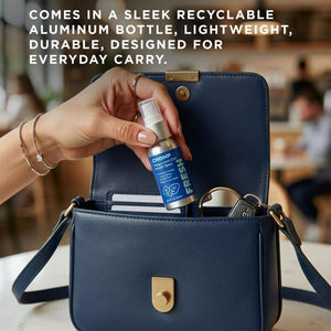 Hand holding a small spray bottle over a blue handbag with text about recyclable aluminum bottles.