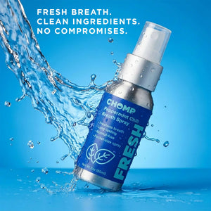 Chomp breath spray bottle with water splash on a blue background