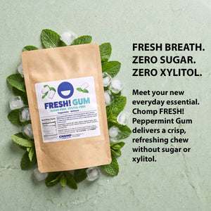 A kraft paper stand-up pouch of Fresh! Gum peppermint sugar-free gummies, shown on a white background with two white gummies and mint leaves.