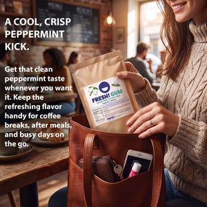 A woman in a cozy cafe setting holds a pouch of Fresh! Gum Peppermint Gum in her brown leather tote bag. The image includes promotional text highlighting the cool, crisp peppermint kick of the gum.