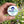 FRESH! gum tin being held by a male hand with an outdoor background of flowers and green grass.