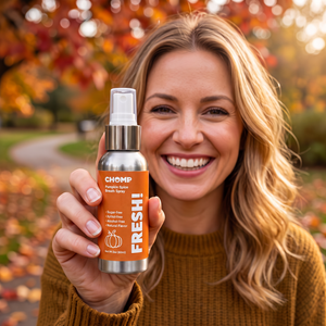 Pumpkin spice breath spray bottle being held by woman outside in the fall.