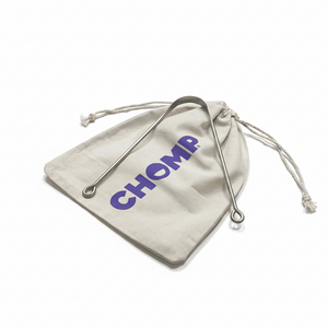 Beige drawstring bag with 'CHOMP' branding on a bathroom counter.
