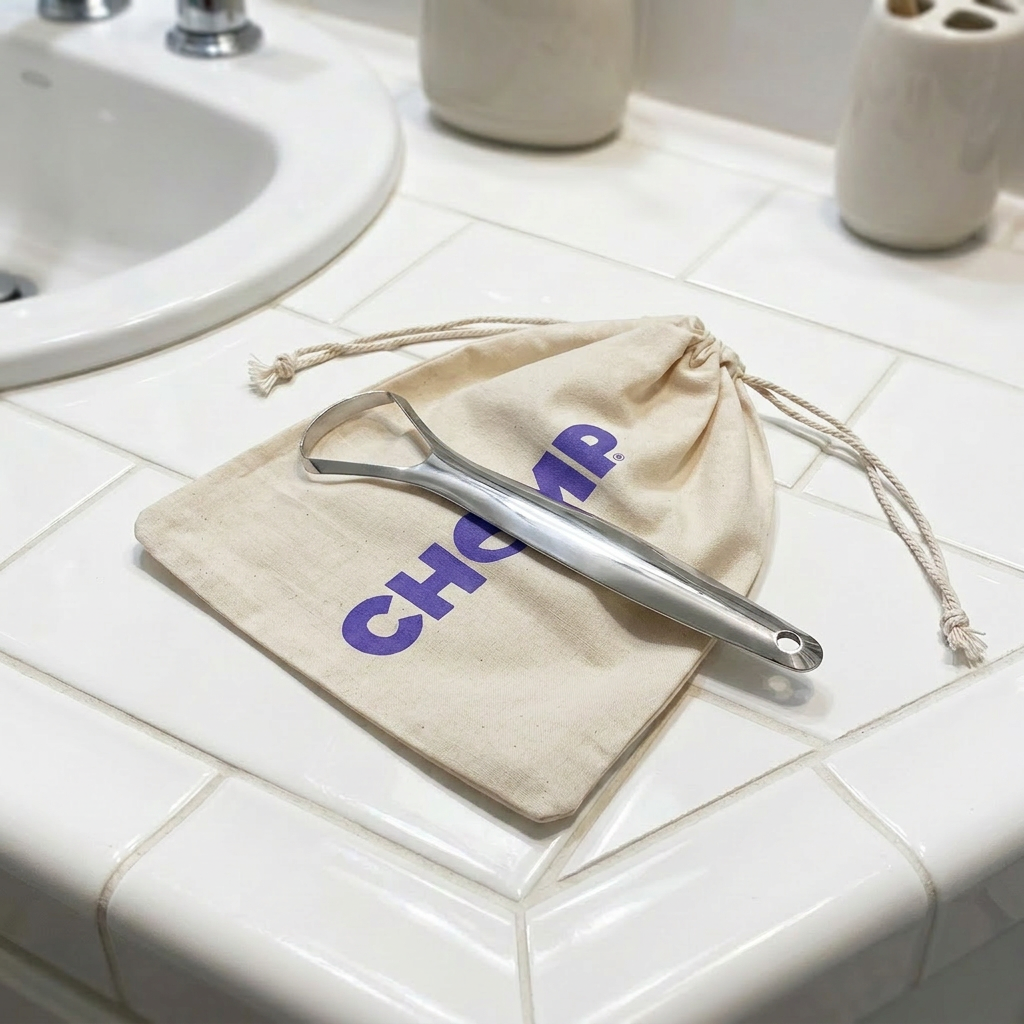 Metallic tool on a beige drawstring bag with 'Chop' branding on a bathroom counter.