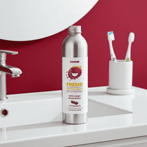 Chomp mouthwash bottle on a bathroom counter with toothbrushes in the background