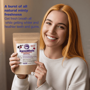 A smiling woman with long red hair holds a stand-up pouch of NanoMints mouth freshener. The pouch is kraft brown with a white label featuring purple and black text and graphics.