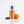 Pumpkin Spice Breath Spray Bottle on a white background with cinnamon stick and small pumpkin behind it.