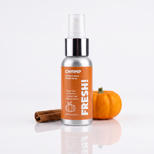 Pumpkin Spice Breath Spray Bottle on a white background with cinnamon stick and small pumpkin behind it.