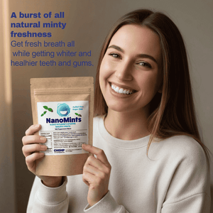 A smiling woman in a cream sweatshirt holds a stand-up pouch of NanoMints natural minty freshness mouth freshener. The background is a soft beige wall with blue promotional text on the left side.