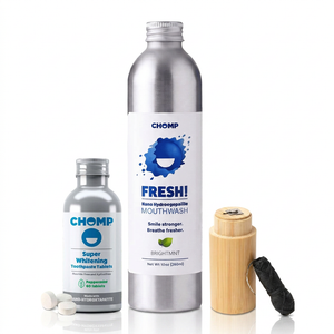 CHOMP Fresh! Mouthwash kit featuring a large silver aluminum bottle, a smaller silver bottle of tablets, a bamboo box, and a black cloth, displayed on a clean white background.