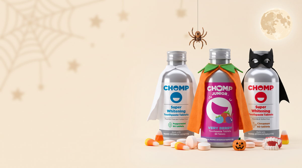 Three chomp bottles dressed up for halloween.