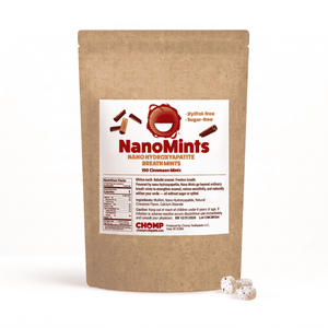 A kraft paper stand-up pouch of NanoMints Breath Mints with a white label, shown on a white background with three mints in front.