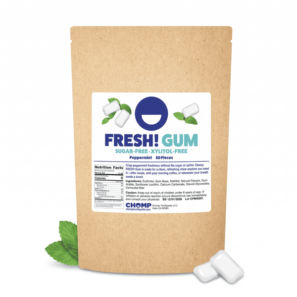 A kraft paper stand-up pouch of Fresh! Gum peppermint sugar-free gummies, shown on a white background with two white gummies and mint leaves.