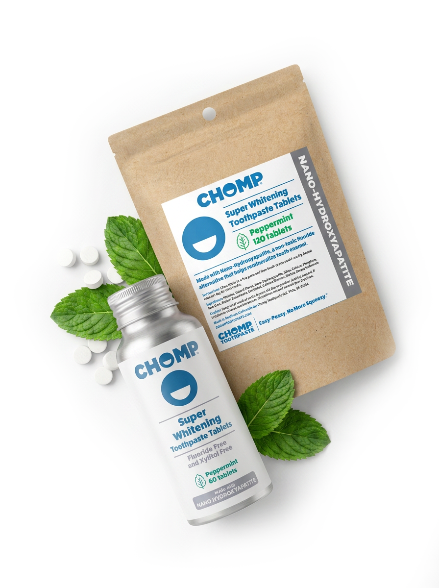 A bottle and pouch of CHOMP Super Whitening Toothpaste Tablets in peppermint flavor, styled with mint leaves and loose tablets on a clean white background.