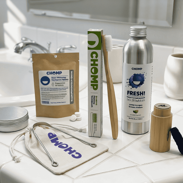 Zero-waste products including a toothbrush, toothpaste, and reusable containers on a bathroom counter.