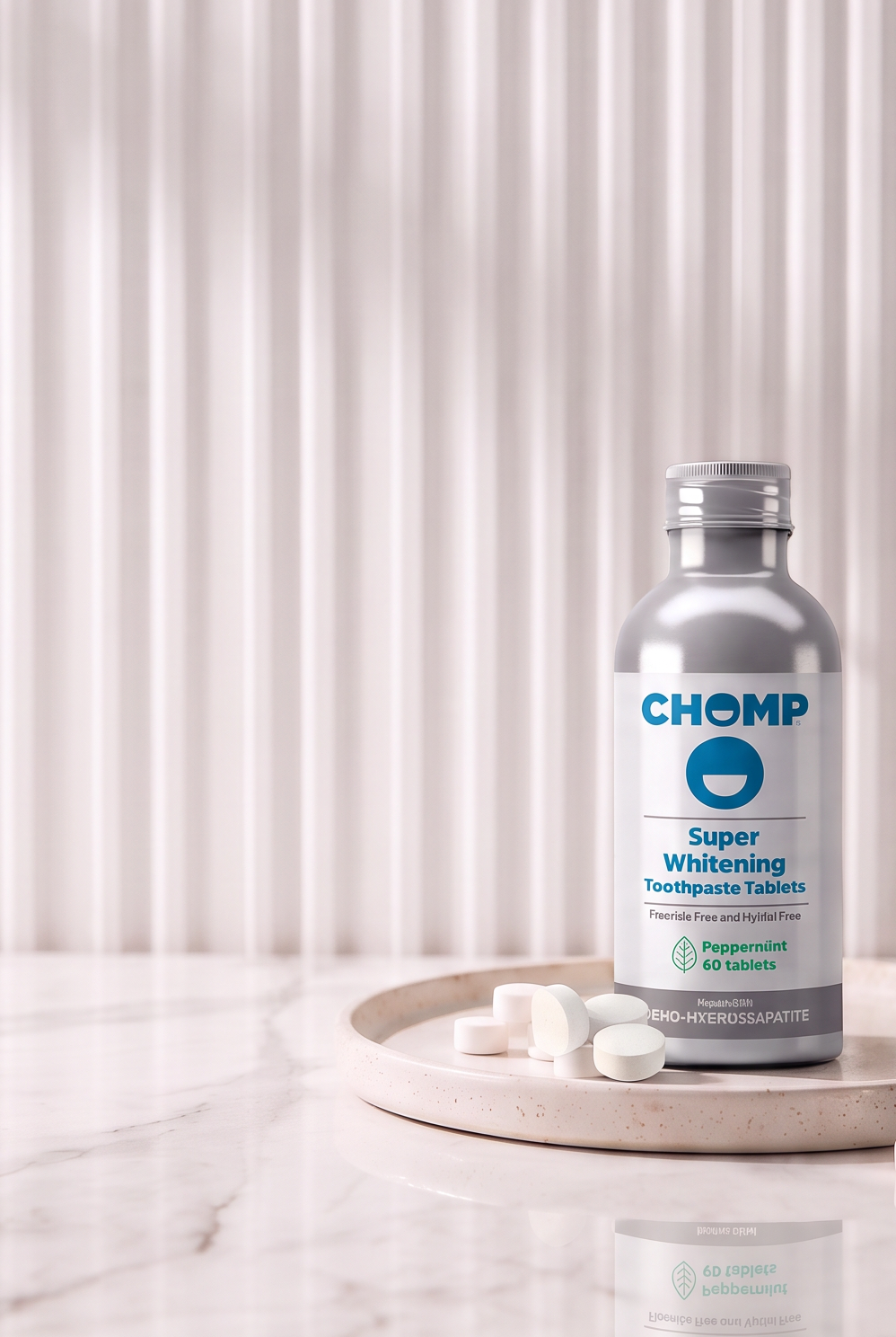 A bottle of CHOMP Super Whitening Toothpaste sits on a marble tray on a white marble countertop, styled with toothbrushes and a towel against a white ribbed background.
