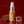 CHOMP breath spray bottle with cinnamon sticks and ice cube on a red background