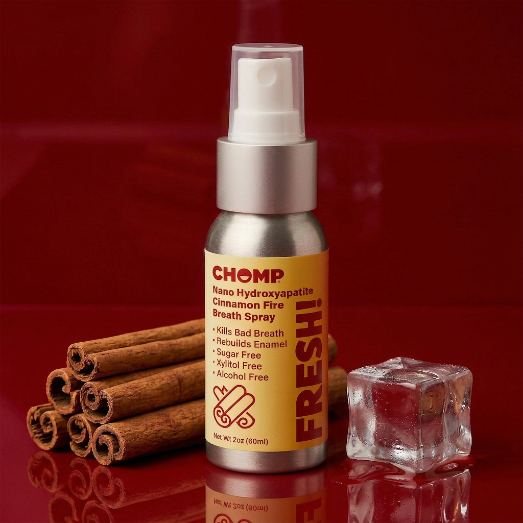 CHOMP breath spray bottle with cinnamon sticks and ice cube on a red background