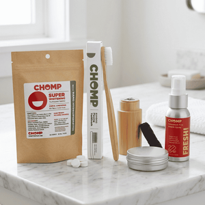 Collection of CHOMP dental care products on a marble surface.
