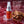 Chomp cinnamon fire breath spray with cinnamon sticks and ice cubes on a red background