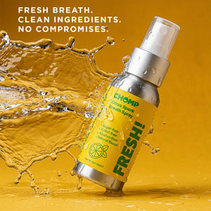 Chomp breath spray bottle with water splash on a yellow background