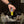 Hand placing a spray bottle into a bag with text about recyclable aluminum bottle.