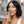 Woman using a breath freshener spray with text about lemon lime freshness in a bathroom setting.