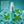 Chomp Spearmint Splash Breath Spray bottle with mint leaves and ice cubes on a teal background