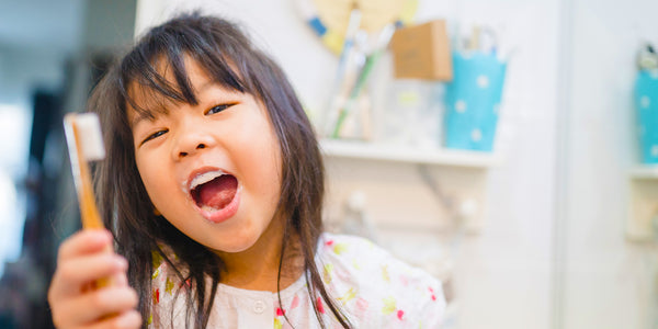Child brush teeth with NHAP toothpaste tablets