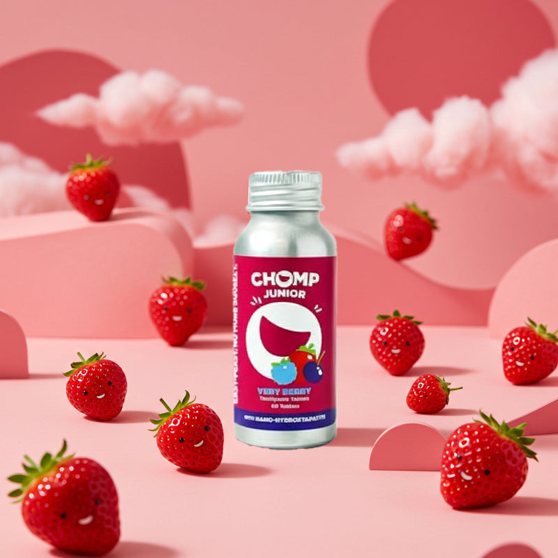 Bottle of Chomp Junior on a pink background with cartoon strawberries