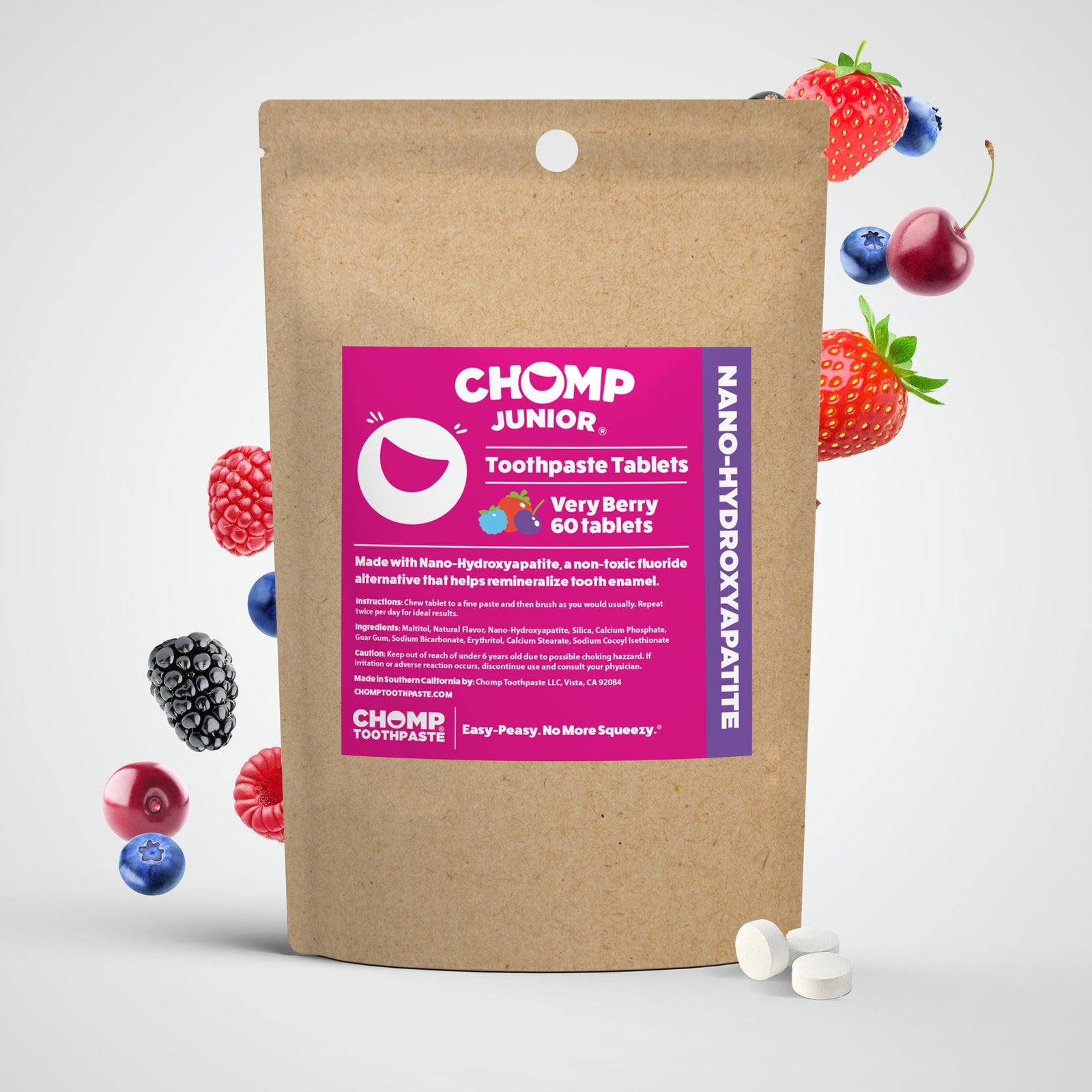 Chomp Junior toothpaste tablets packaging with berries on a white background