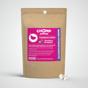 Chomp Junior toothpaste tablets packaging with a pink label on a white background