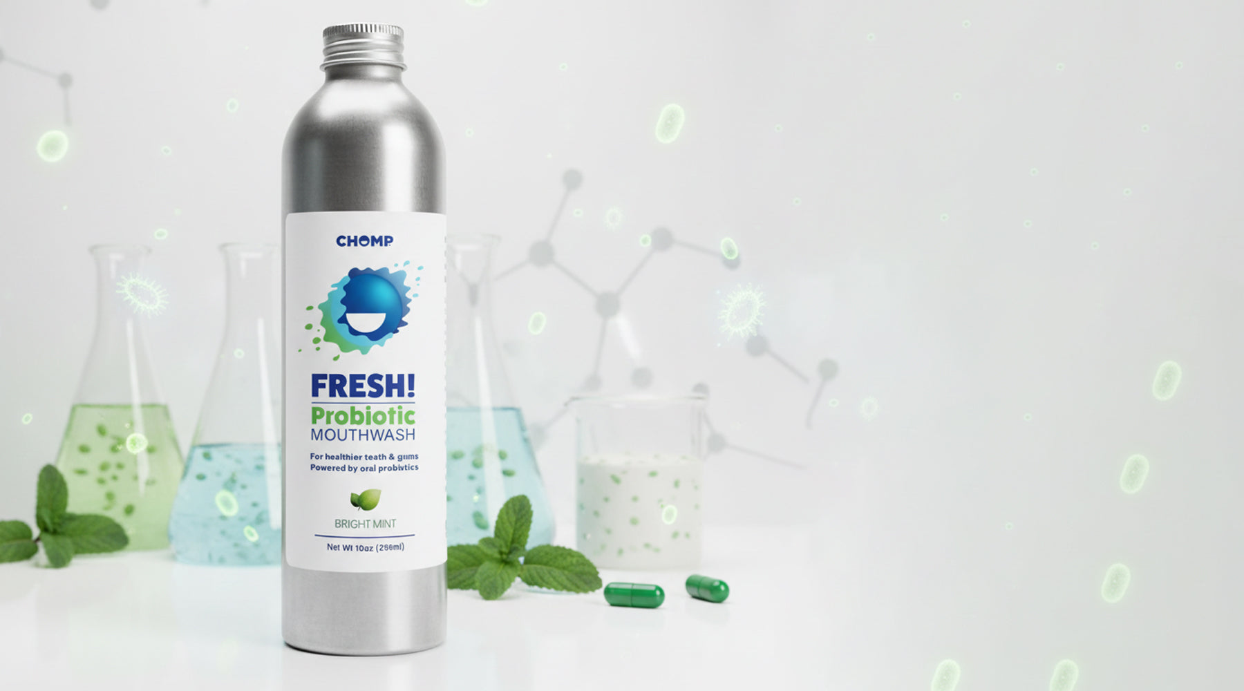 Silver bottle of Chomf Freshi Probiotic Mouthwash with green leaves and scientific glassware in the background.