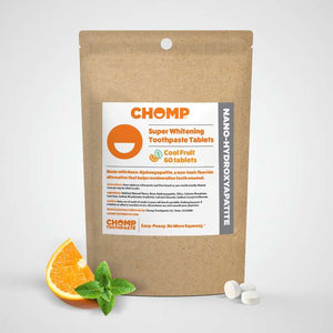 CHOMP super whitening toothpaste tablets packaging with an orange and mint leaf on a white background