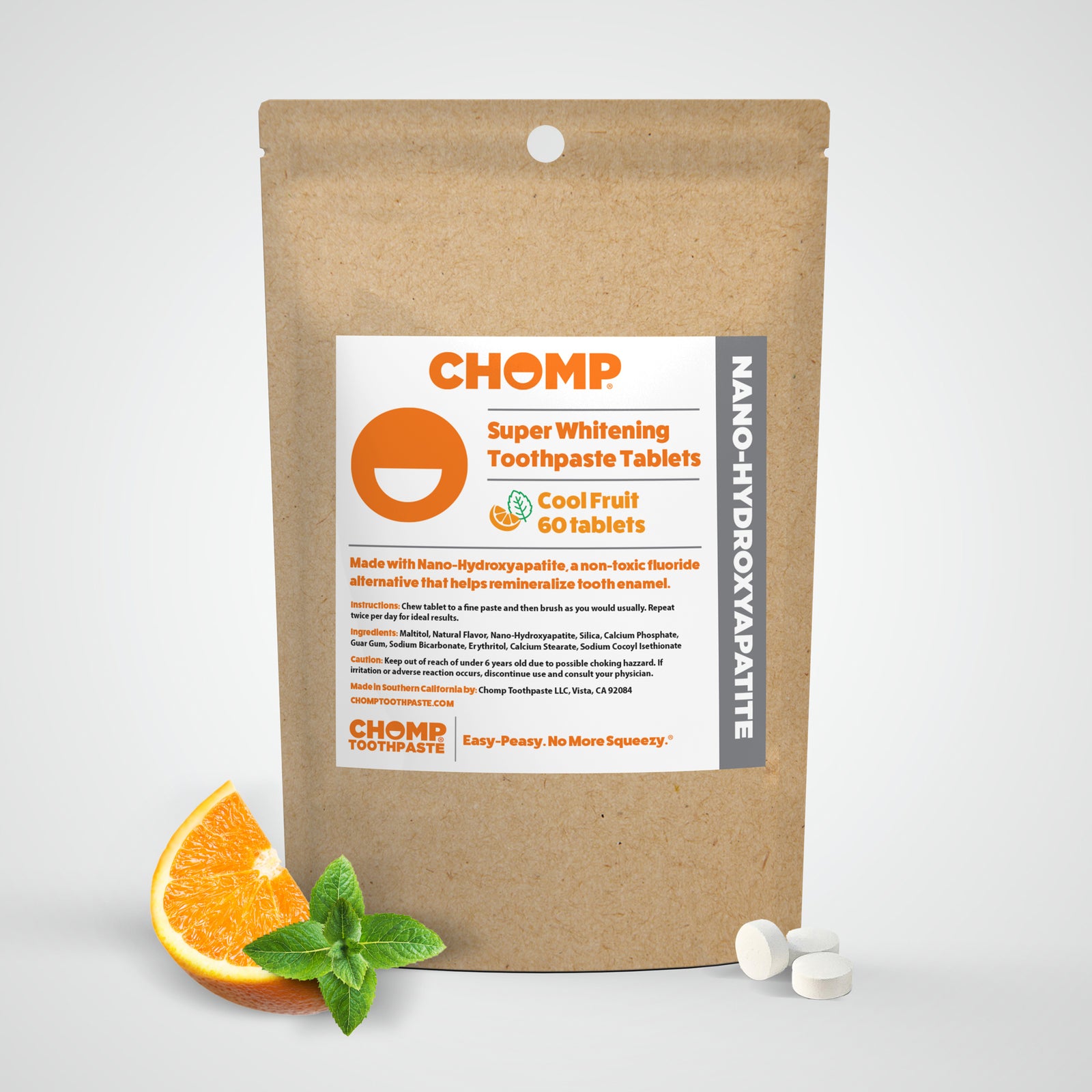 CHOMP super whitening toothpaste tablets packaging with an orange and mint leaf on a white background