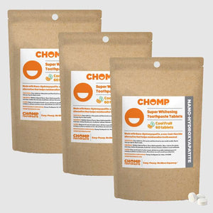 Three packages of CHOMP Super Whitening Toothpaste Tablets on a light gray background