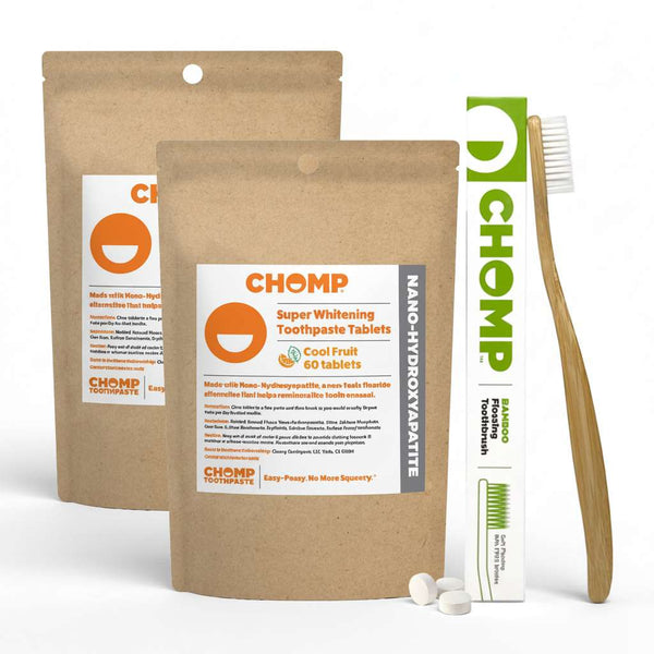 CHOMP toothpaste tablets packaging with a toothbrush on a light gray background