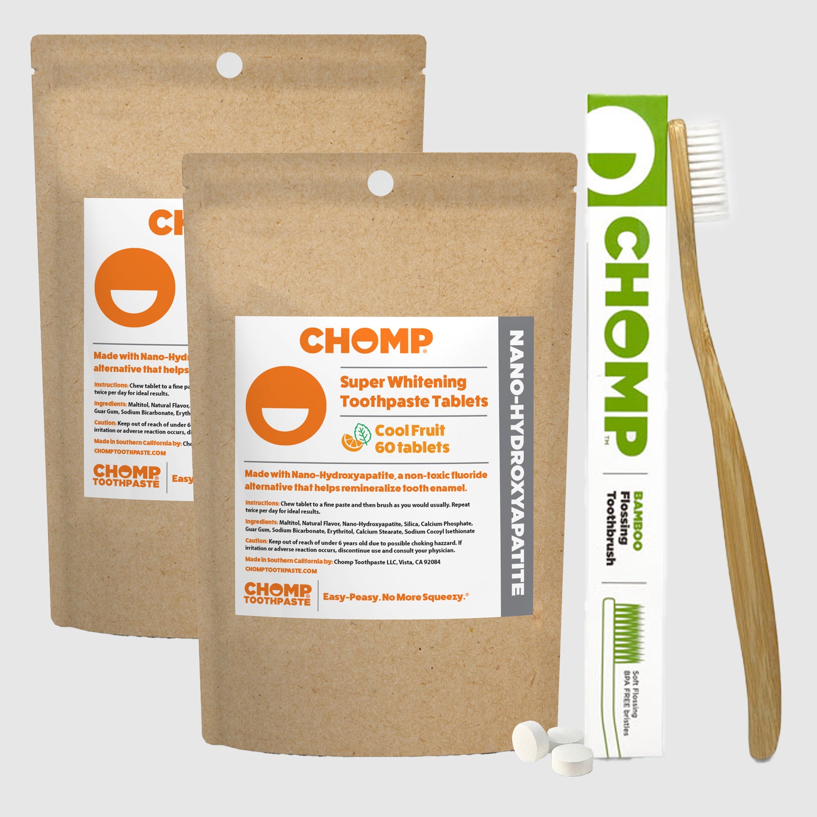 CHOMP toothpaste tablets packaging with a toothbrush on a light gray background