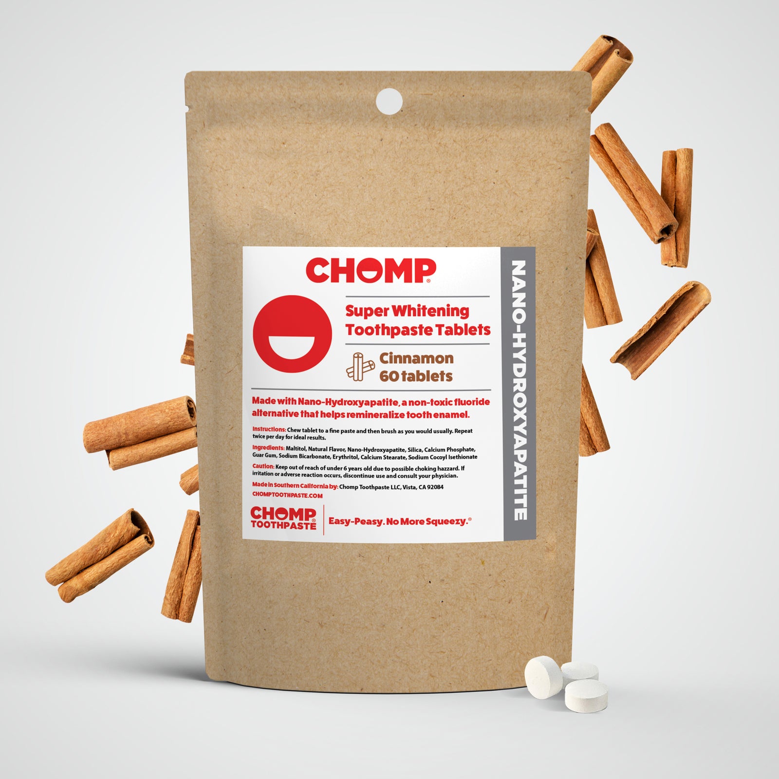 CHOMP super whitening toothpaste tablets packaging with cinnamon sticks on a light gray background