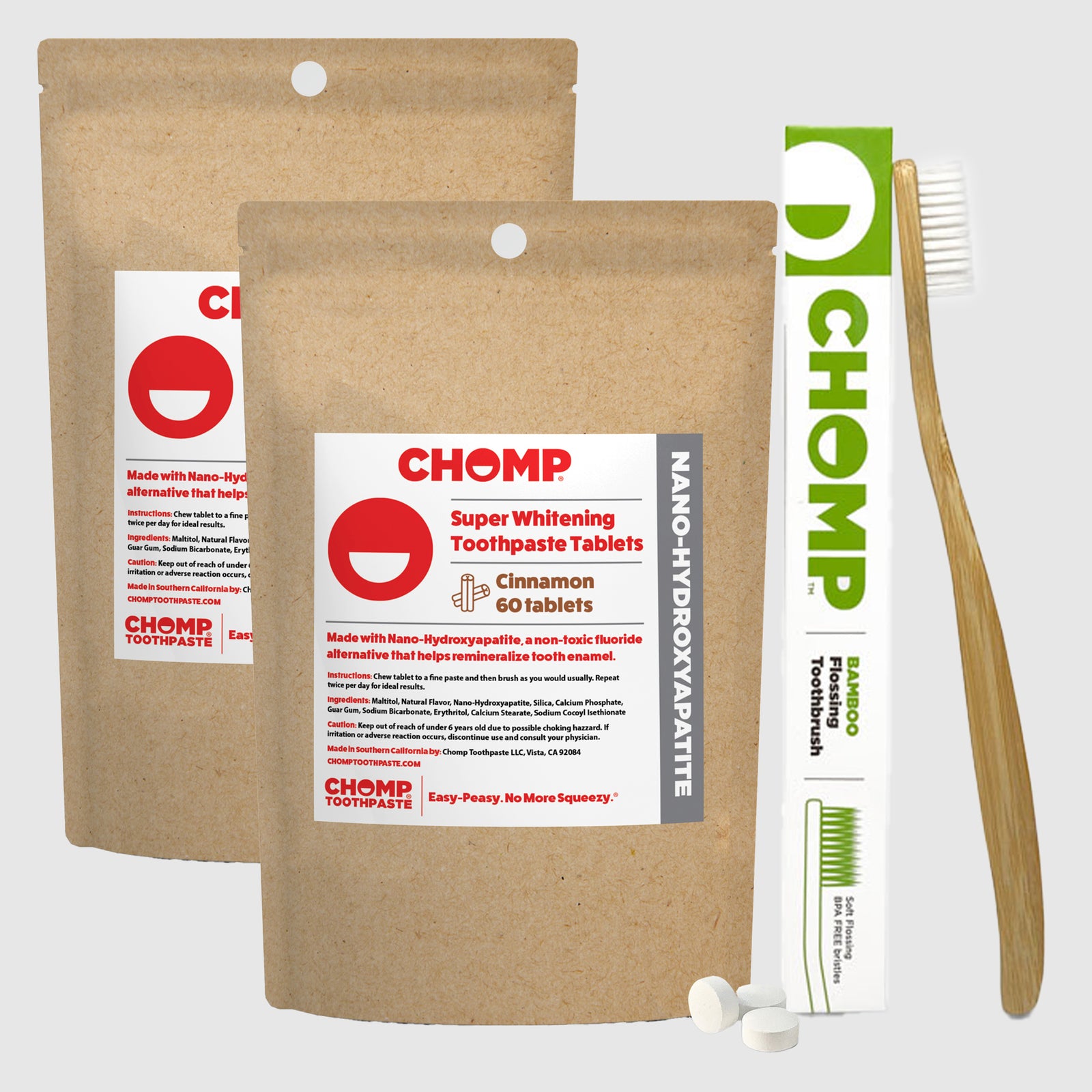 CHOMP toothpaste tablets packaging with a toothbrush on a light gray background