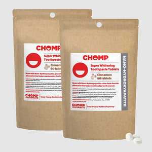 Two packages of CHOMP Super Whitening Toothpaste Tablets on a light gray background