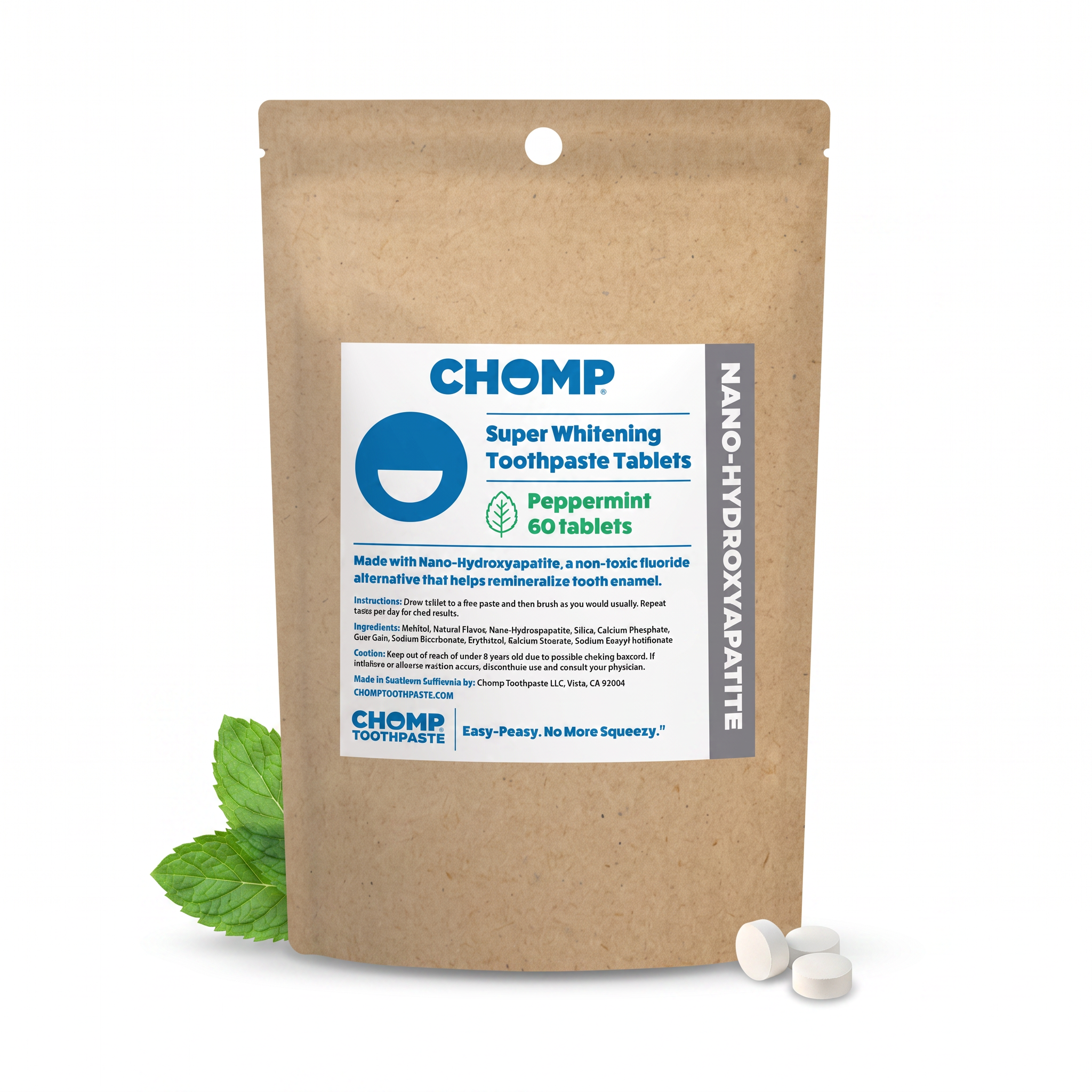 A stand-up kraft paper pouch of CHOMP Super Whitening Toothpaste Tablets in Peppermint flavor, shown on a white background with two white tablets in front and mint leaves at the base of the pouch.